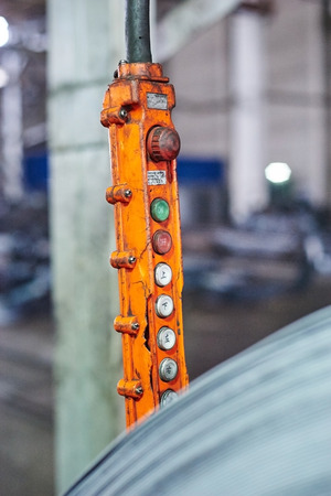Rolls of steel sheet orange remote control. Close up image