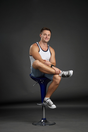 Portrait of a relaxed man sitting on a bar stoolの写真素材