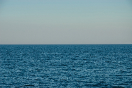 Deep blue sea horizon. Clear blue sky and sea backgroundの写真素材