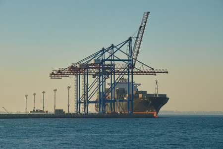 ODESSA, UKRAINE - JULY 18, 2017: Large container vessel in Port of Odessa. Cargo cranes on rails and...