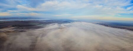 Aerial landscape. Fog above the fields. Bird eye view landscape.
