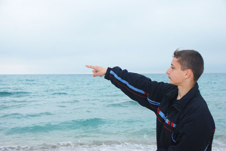 Boy look at sea stormの写真素材