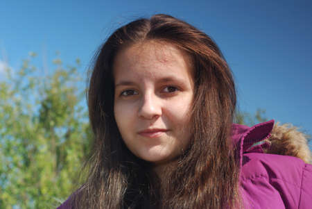 Smiling teenager girl in jacketの写真素材