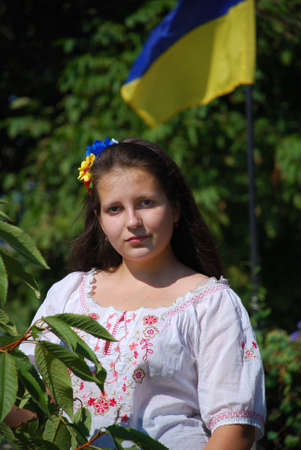 teenager girl in ukrainian national suit on flag backgroundの写真素材