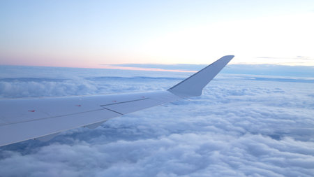 Clouds and sky as seen through window of an aircraft