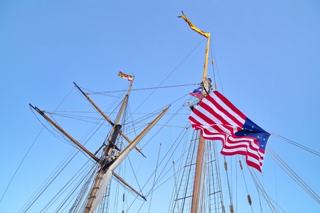 Tall ship Pride of Baltimore II masts with US flag on it, Toronto harborfront, Canadaの写真素材