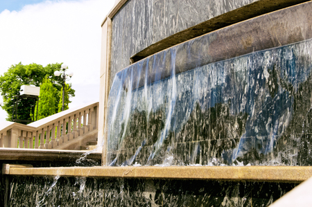 Flowing water in a city fountainの写真素材