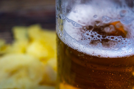 Glass of beer close up on a blurred backgroundの写真素材