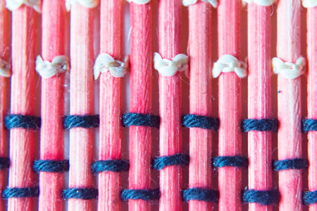 Purple sticks interlaced with black rope.の写真素材