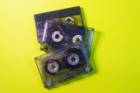 Three vintage cassettes on a yellow background.の写真素材