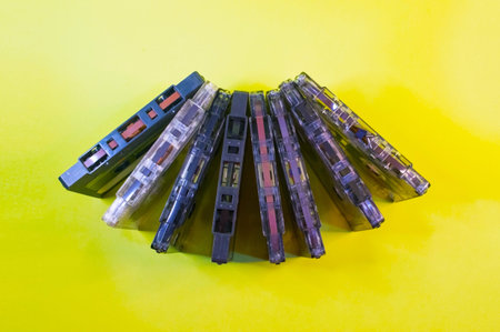 A row of cassettes on a yellow background.