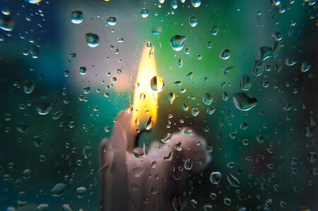 Blurred background on glass and raindrops on itの写真素材