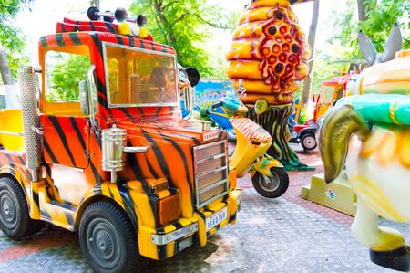 Big truck on a children's carousel in an amusement parkの写真素材