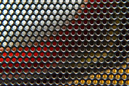 Abstract colored background metal grid closeup.の写真素材