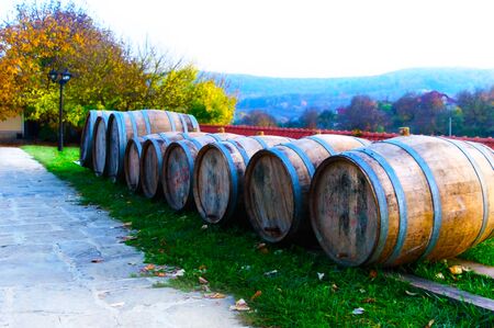 Wooden wine barrels in the courtyard of the monastery in the fallの写真素材