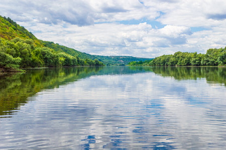 The water of the Dniester river close-up with forests on the sides made from a boat.の写真素材
