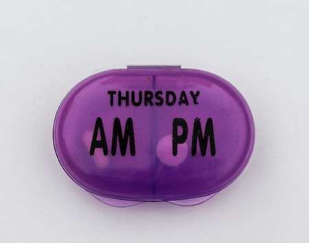 Plastic container of pills isolated on a white backgroundの写真素材