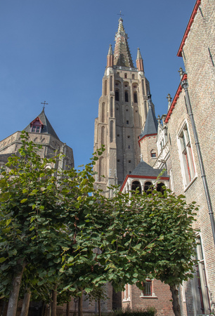 Traditional old church with towers typical of the skyline in Brugesの写真素材