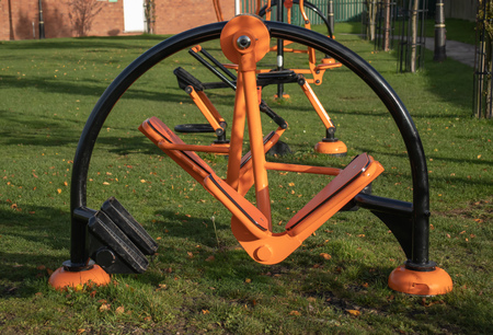 A set of orange and black exercising machines for public useの写真素材