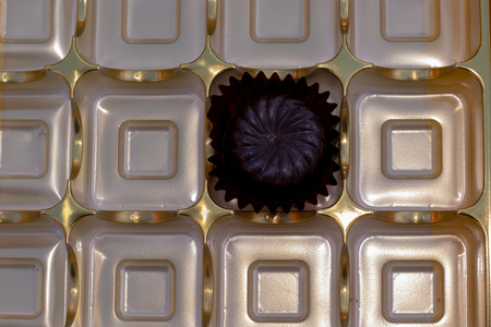 One tempting, luxury, dark chocolate left in the attractive boxの写真素材