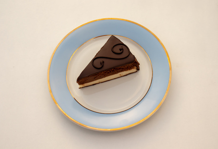 Chocolate and vanilla cake with fondant icing on a plateの写真素材