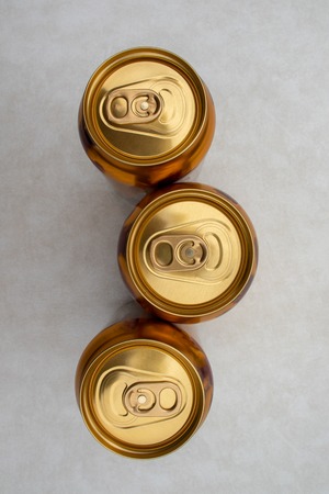 top-down view of three cans of ginger beer isolated on a light backgroundの写真素材