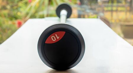 view of a meta bar-bell used for exercising, at rest on a tableの写真素材