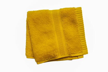 Small rectangular yellow face cloth isolated on a white backgroundの写真素材
