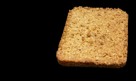 top-down view of home-made flapjack isolated on a black background