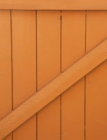 Front view of a section of garden gate painted in light brownの写真素材
