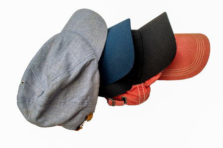 Side view of assorted baseball caps isolated on a white backgroundの写真素材