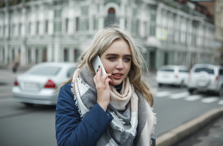 The girl on the street speaks by mobile phoneの写真素材