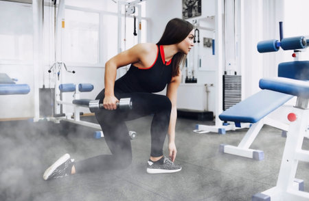 Athletic young woman doing a fitness workout with weights