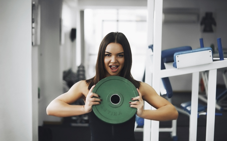 Athletic young woman doing a fitness workout with weightsの写真素材
