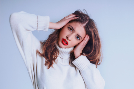 Beautiful girl with red lips, showing her emotion.の写真素材