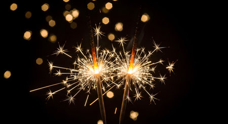Christmas and newyear party sparkler on black bokeh backgroundの素材