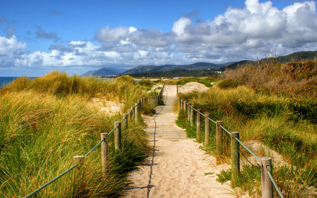 Boardwalk through the sand dunes on beach in Portugalの写真素材