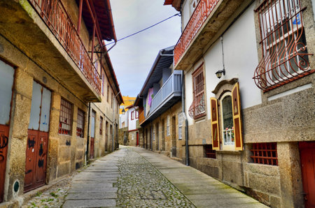 Old street in the heart of the tradition of tanning and beating hides in Guimaraes, Portugalの写真素材