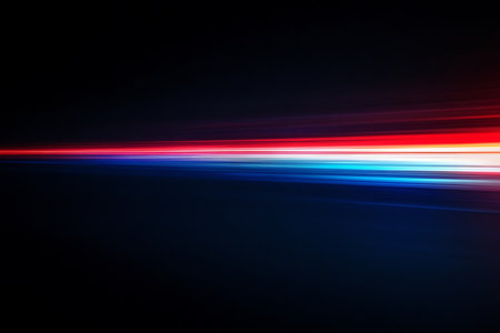 Dynamic abstract composition featuring streaks of vibrant red blue and white light blurred to convey a sense of speed and energy. Evokes a futuristic and technological feel.の素材