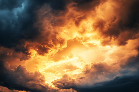 A dramatic and powerful depiction of a sky ablaze with vibrant orange and yellow hues, as if a celestial explosion is occurring amidst swirling dark storm clouds.の素材