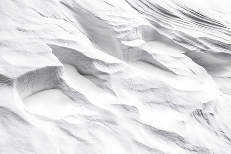 A close-up view of a textured white surface, showcasing subtle shadows and highlights. The abstract pattern evokes natural formations or organic shapes with a sense of gentle movement and depth.の素材