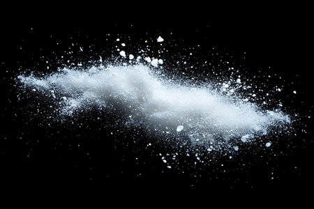A vivid explosion of fine blue and white powder creates a dramatic, abstract shape frozen in time. The dynamic particles scatter outwards, suggesting energy and movement in this striking visual.の素材