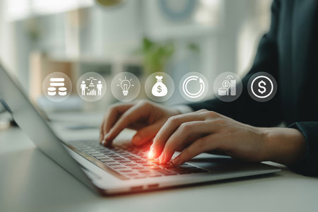 Close-up of a businessperson's hands typing on a laptop keyboard with abstract financial and data management icons floating above. Represents digital transformation, investment, and strategic planning.の素材