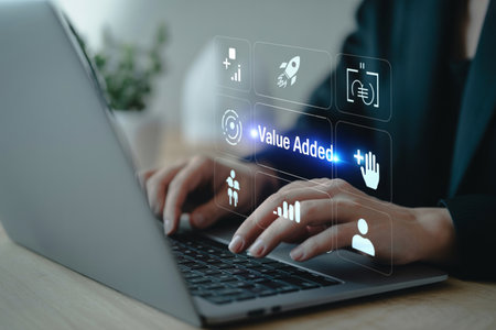 Professional hands typing on a laptop, interacting with a digital interface showcasing 'Value Added' and various business icons. This illustrates strategic growth, enhancing services, and competitive advantage through modern technology and innovation for market success.の素材