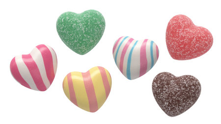 Six heartshaped candies with different colors and patterns on white backgroundの素材