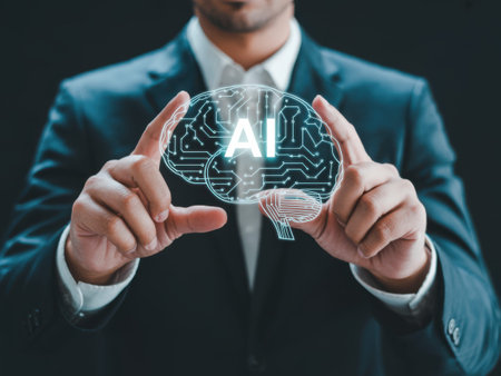 A man in a dark blue suit and white shirt holds a glowing artificial intelligence brain between his index fingers. The brain a circuit board with the letters AI in the center. The background......の素材