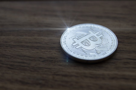 Bitcoin cryptocurrency coin on a wooden surfaceの写真素材