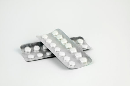 Pills in transparent packaging on a white backgroundの写真素材