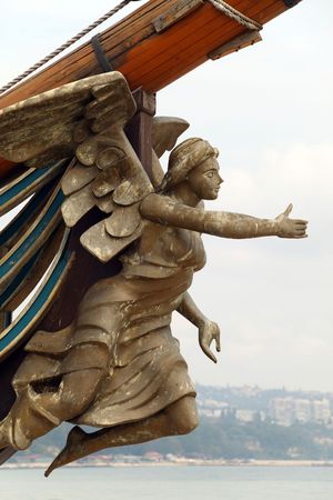 Statue of a woman with outstretched hand fixed on a bow of a tall ship replicaの写真素材