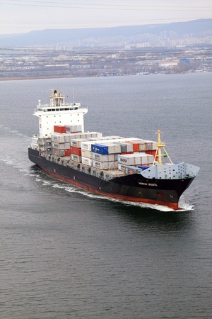 VARNA, BULGARIA - DECEMBER 14: Cargo ship WARNOW VAQUITA (Year Built: 2008) sails into open sea on December 14, 2010 in Varna, Bulgaria. Ship`s next destination is Constanta, Romania.のeditorial素材